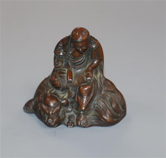 An Oriental patinated metal figure group 6cm high